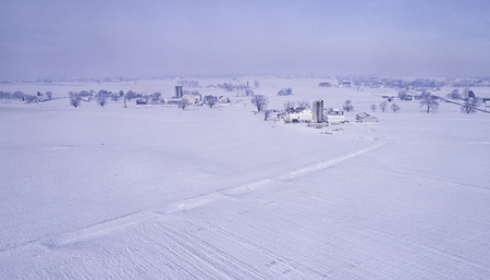 An Aerial View of a Snowy morning in Amish Farmlandの写真素材