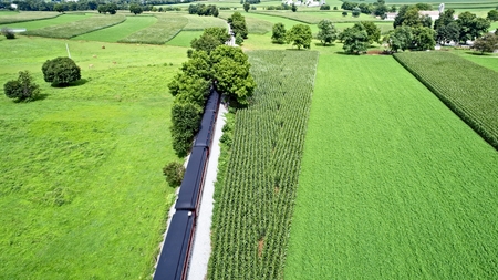 Aerial View of Amish Farmlands by Rail Road Tracksの写真素材