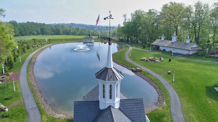 Aerial View of a Steeple or Cupola and Pond as Seen by a Droneの写真素材