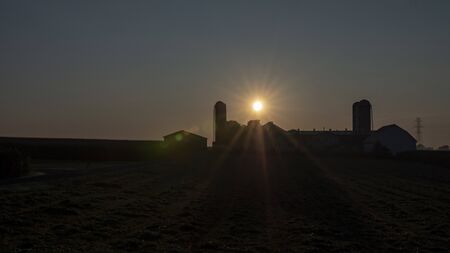 An Aerial View of a Sunrise Over an Amish Farm with Blues and Reds on a Clear Summer Morningの写真素材
