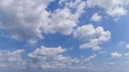 White and Dark Fluffy Clouds Floating in the Bright Blue Skies on a Summer Dayの写真素材