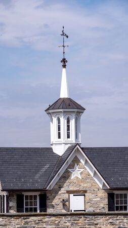View of a Steeple Cupolas with a Weather Vane on a Sunny Summer Dayの写真素材