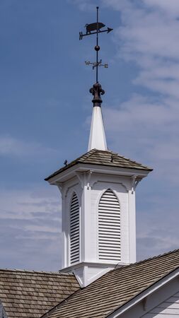 View of a Steeple Cupolas with a Weather Vane on a Sunny Summer Dayの写真素材