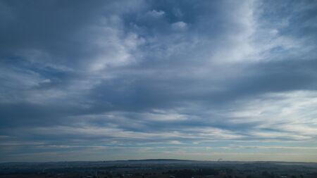 Aerial View of a Late Afternoon Sun With Partly Cloudy Blue Sky Over Farm Countryside Backgroundの写真素材