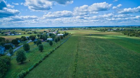 Aerial view of Amish countryside with barns and silos on a sunny summer dayの写真素材