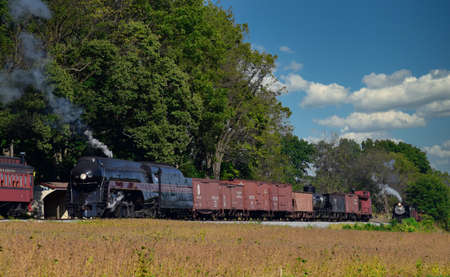 Strasburg, Pennsylvania, October 2019 - 2 Antique Steam Freight Train Puffing Smoke and Steam While...