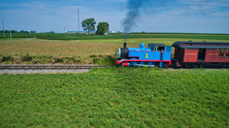 Ronks, Pennsylvania, June 2019 - Aerial View of Thomas the Tank Engine Approaching Pulling Passenger Cars Blowing Smoke on a Beautiful Sunny Dayのeditorial素材