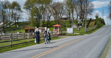 Teenage Amish Boys and Girls Walking Along a Rural Road in the Countryside on a Spring Dayの写真素材
