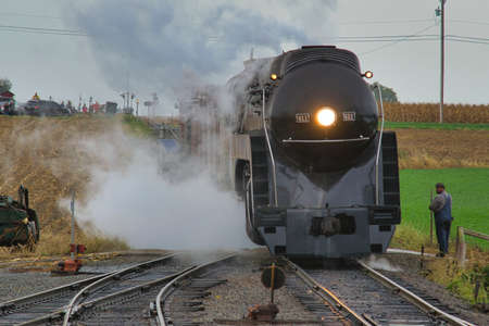 An Antique Restored Steam Freight Train Approaching Head on Blowing Smoke and Steam