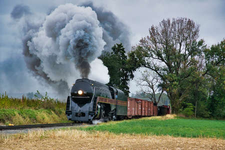 Ronks, Pennsylvania, October 2019 - An Antique Restored Steam Freight Train Approaching Blowing Smoke and Steamのeditorial素材