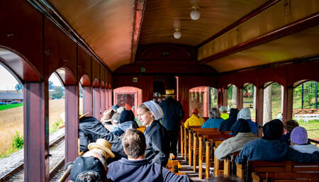 Ronks, Pennsylvania, October 2019 - Amish People Taking A Train Ride in an Open Air Car on a Sunny Fall Dayのeditorial素材