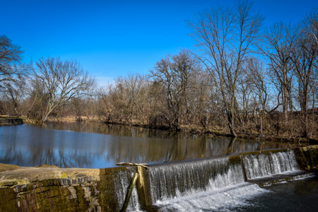 A View of a Man Made Dam and Waterfall, Found in the Countryside on a Sunny Winter Dayの写真素材
