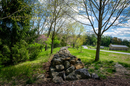 View of a Hand Made Stone Wall in the Countryside on a Spring Dayの写真素材