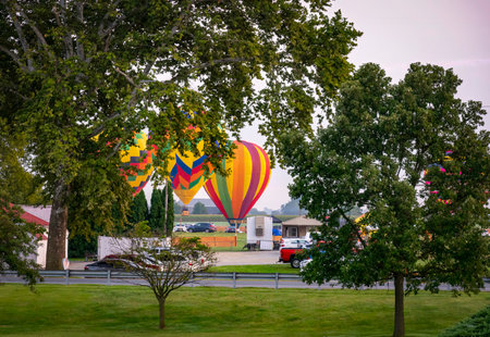 Morning Sunrise Launch Of Hot Air Balloons During a Balloon Festival on Summer Dayの写真素材