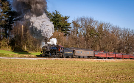 Ronks, Pennsylvania, December 12, 2022 - A View of a Classic Steam Passenger Train, Blowing Lots of...