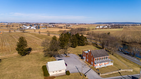 An Aerial View of Rolling Harvested Farmlands, in Rural America, on a Sunny Winter Dayの写真素材