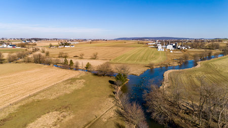 An Aerial View of Rolling Harvested Farmlands, in Rural America, on a Sunny Winter Dayの写真素材