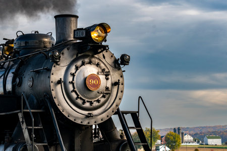 Ronks, Pennsylvania, November 4, 2023 - A Close Up View of the Front of an Antique Steam Locomotive Blowing Smokeのeditorial素材