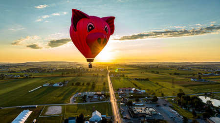 Bird in Hand, Pennsylvania, September 14, 2023 - An Aerial View of a Pig Head Hot Air Balloon, Floating Over Pennsylvania Farmlands at Sunrise, on a Summer Dayのeditorial素材