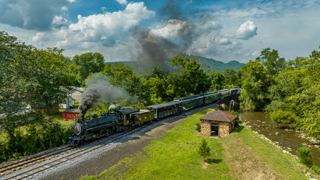 Rockhill Furnace, Pennsylvania, August 5, 2023 - An Aerial View of a Steam Narrow Gauge Passenger Train Heading South Over Blacklog Creek on a Sunny Dayのeditorial素材