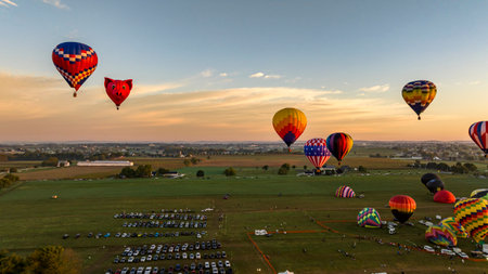 Bird in Hand, Pennsylvania, September 17, 2023 - An Aerial View of Hot Air Balloons Floating Away One is a Pigs Head, in Rural Pennsylvania at Sunrise on a Sunny Summer Morningのeditorial素材