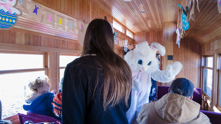 Rockhill, Pennsylvania, April 1, 2023 - An Easter Bunny Meeting Kids in a Rail Road Passenger Car Celebrationのeditorial素材