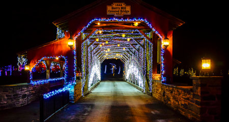 Elizabethtown, Pennsylvania, USA, December 8,2023 - Twinkling Blue And White Lights Line The Interior Of Herrs Mill Covered Bridge From 1844, Creating A Festive Tunnel Effect At Night,のeditorial素材