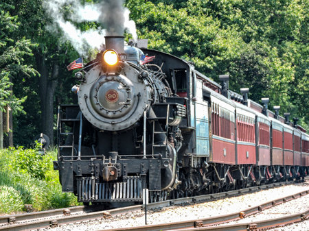 Ronks, Pennsylvania, July 1, 2022 - A View of A Restored Steam Passenger Train Approaching Traveling Thru Rural America on a Sunny Dayのeditorial素材