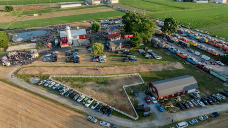 Ronks, Pennsylvania, USA, July 3, 2024 - Aerial View Of A Farm Event Featuring A Red Barn, Crowds, Food Trucks, Parking Lots, And Surrounding Fields.のeditorial素材