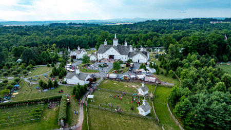 Elizabethtown, Pennsylvania, USA, July 4, 2024 - Picturesque Rural Fair With White Barns, Small Churches, Food Trucks, And People Enjoying Festivities Amidst Green Trees And Rolling Hills, Creating A Charming Community Atmosphere.のeditorial素材