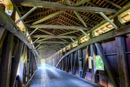 Detailed wooden beams create a beautiful pattern across the ceiling of an aged barn, highlighting the construction techniques used in historic rural architecture.の写真素材