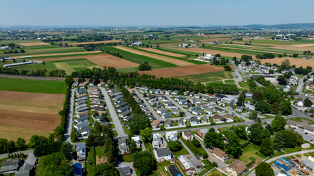This aerial perspective shows a well-planned mobile, manufactured home park, nestled amid vast...