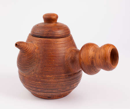 earthenware teapot isolated on whiteの写真素材