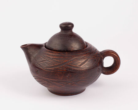 earthenware teapot isolated on whiteの写真素材