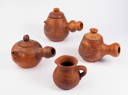 earthenware teapots and jug isolated on whiteの写真素材