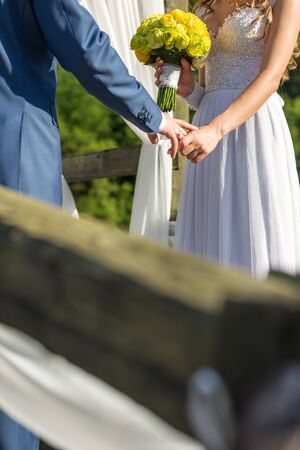 bride and groom holding hands at the time of marriageの写真素材