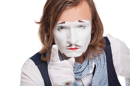 serious mime actor shows his forefinger at the viewerの写真素材