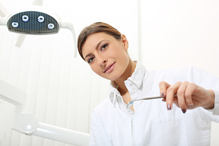 beautiful woman dentist ready to examine the patientの写真素材