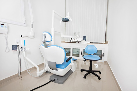 Modern dentist's chair in a dental office with X-ray and sensory lampの写真素材