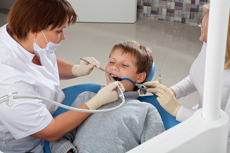 Dentist makes mechanical cleaning of the teeth to the patientの写真素材