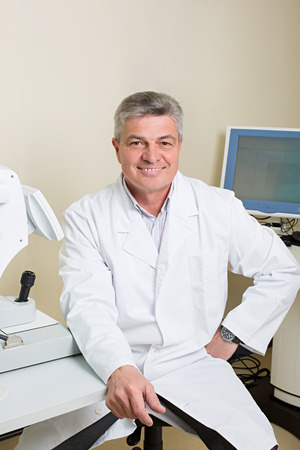 Optometry concept -  portrait of handsome elderly eye doctorの写真素材