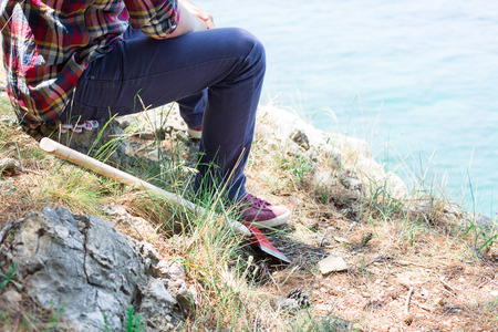 Portrait of an attractive young lumberjack who is resting after cutting a tree