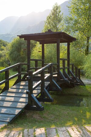 wooden bridge over a stream in the parkの写真素材