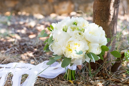 rustic bridal bouquet of white peoniesの写真素材