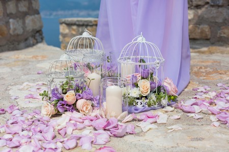 White cage with natural roses as decoration on weddingの写真素材