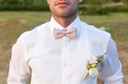 Attractive groom is looking forward to the appearance of the brideの写真素材