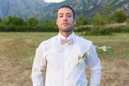 Attractive groom is looking forward to the appearance of the brideの写真素材