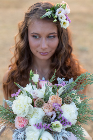 Attractive bride is holding a magnificent wedding bouquetの写真素材