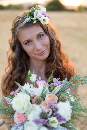 Attractive bride is holding a magnificent wedding bouquetの写真素材