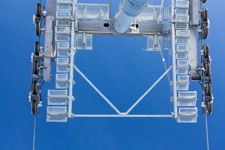 Ski lift with seats going over the mountain and paths from skies and snowboardsの写真素材